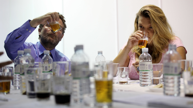 Beer judges gravely evaluate a beer’s merits. (Photo: Oli Scarff/Getty Images)